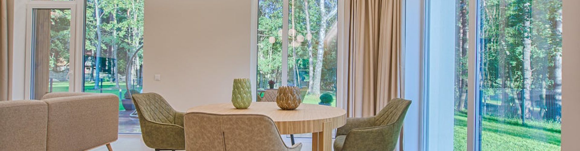 Elegant dining room featuring modern furniture and large windows for natural light.
